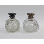 A pair of silver topped glass scent bottles, (with loose lid) Birmingham 1912, 11cm (2)