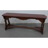Mahogany bench with pieced side supports and stretcher, 49 x 123cm