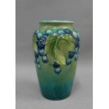 Moorcroft grapes and vine pattern baluster vase with a green ground, with facsimile signature and