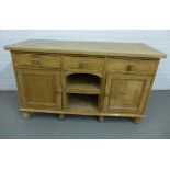 Pine cabinet with three drawers over a central alcove, flanked by cupboard doors, 90 x 153cm
