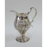 George III silver cream jug with embossed decoration of flowers, on a circular footrim, Nathaniel