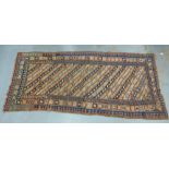 Gendje long rug with an allover striped and geometric pattern within multiple borders, 1235 x 310cm