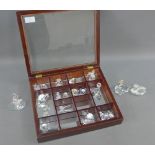 Showcase containing a collection of Swarovski and other miniature crystal animals, etc (a lot)