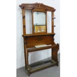 Late 19th century oak hall stand with a pierced top rail above a central mirror with a surround of