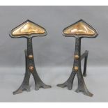 Pair of Art Nouveau steel and copper fire dogs, 35cm (2)