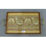 Rectangular glazed tray containing a Leek Society style embroidered festoon panel, size overall 46 x