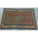 Kazak rug, with a worn red ground with five geometric medallions within multiple borders, 196 x