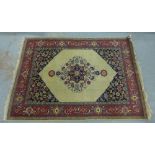 North West Persian rug with an ivory field with central flowerhead medallion within red and blue