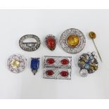 A collection of white metal citrine and coloured hardstone brooches and buckles and a yellow metal