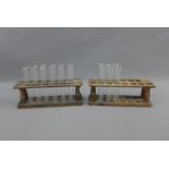 Two vintage pine stands containing a quantity of glass test tubes, (a lot)