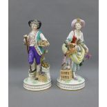 Pair of porcelain male and female figures, the female with a duck and hen and the male with basket