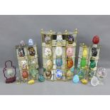 A collection of glass and cloisonne decorative eggs together with three brass and glass display
