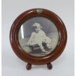 Early 20th century circular hardwood photograph frame with a small white metal map of Tasmania to