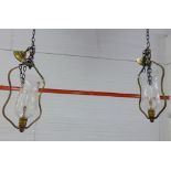 A pair of Baccarat brass framed hanging ceiling lights with etched glass storm style shades,