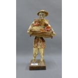 Papier mache figure on a square wooden base, 33cm