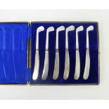 Cased set of six mother of pearl and Epns butter knives, the handles in the form of golf clubs,