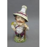 Derby Mansion House Dwarf ‘Peter Corcoran - The Fancy', modelled standing wearing a pointed hat,