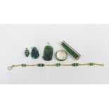 A collection of jadeite jewellery to include a 9ct gold mounted brooch, a ring stamped 14k, a carved