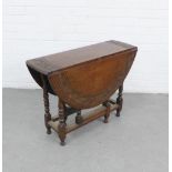 Early 20th century oak gateleg table with circular top with a carved border and drop flaps, 62 x
