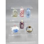 A collection of Chinese and other snuff bottles, one with a red dragon pattern and with a