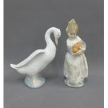 Lladro porcelain girl with a basket of oranges and a Nao duck, tallest 17cm (2)