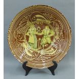 Slip ware terracotta bowl with figures and fish pattern border, 37cm diameter
