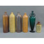 Collection of stoneware bottles and a green glass vase, tallest 33cm (6)