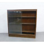 Early 20th century oak bookcase with glass sliding doors and fluted base, 107 x 108 x 24cm