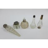 Early 20th century silver topped glass inkwell and a collection of bottles with white metal