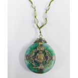 Early 20th century jadeite Buddhist pendant of disc form with filigree mounts, 6cm