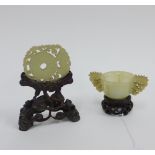 Chinese jade archaic style cup with carved handles and pierced wooden stand, with small rim chip and