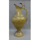 Large Kashmiri, Indian gilt brass engraved jug with a serpent handle, 65cm high