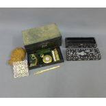 A 19th century leather jewellery box containing miscellaneous items to include a brass dolphin,