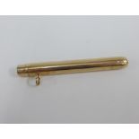 9ct gold pencil holder with push button action to one end, with a suspension loop, stamped 9ct EB,