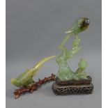 Chinese carved jadeite bird group, on a wooden base, 20cm high, together with another (losses to