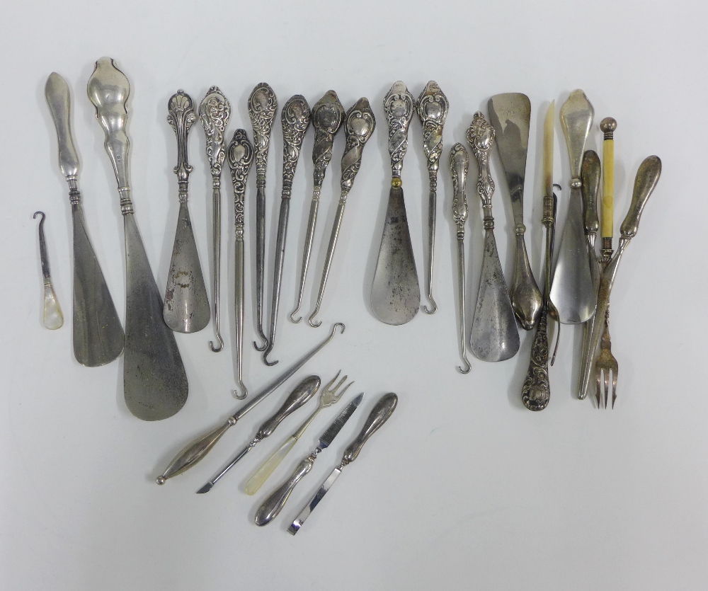 A collection of silver and white metal handled button hooks, shoe horns and pickle forks, etc (a