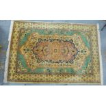 Persian style wool rug, with a pale green and foliate field, 280 x 184cm