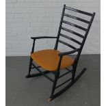 Ebonised rocking chair with horizontal splats, and an orange upholstered seat 92 x 52cm