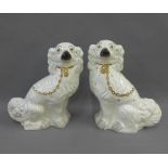 Pair of white glazed chimney spaniels with gilt collars, 32cm high (2)