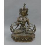 Bronze figure of a Deity, modelled seated in contemplative pose on a lotus base, 21cm high
