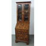 Walnut bureau bookcase, the moulded cornice over a pair of glazed doors with a shelved interior with