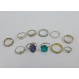 A collection of eleven silver and white metal rings, (11)