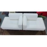 A pair of Cassina sofas / oversized chairs, with removable white covers, one left arm, the other