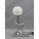 An Art Deco style figural table lamp base with a glass globe shade, 48cm high