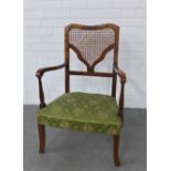 Early 20th century open armchair with a canework back, upholstered seat and sabre legs, 87 x 56cm