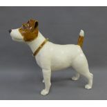 Studio pottery figure of a white glazed terrier dog, signed with a monogram, 33cm high