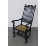 Black painted open armchair with scrolling top rial and vertical splat back, cane work seat and