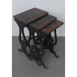 Nest of three ebonised tables with chinoiserie patterned tops and lyre style side supports,