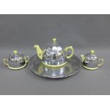 Vintage yellow glazed teaset with chrome metal covers and circular tray, (4)