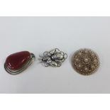 Three vintage silver brooches to include one stamped Sterling Denmark, a wire work brooch stamped